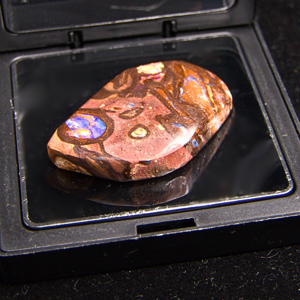 QLDBRSPO-558.1 Chilled Natural Queensland Boulder Opal 93.08 Ct with purple play-of-colour, translucent section, low dome, semi-polished finish, solid opal naturally formed in Queensland, Australia.