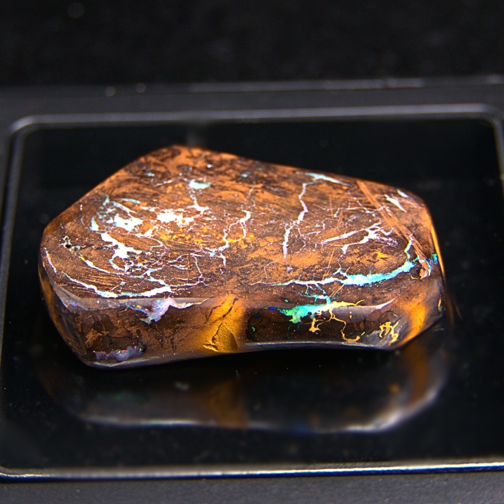 QLDBRSPO-562.2 Adorning Natural Queensland Boulder Opal 134.30 ct with B3 brightness, green, red and pink play-of-colour, translucent seams, low dome, and semi-polished finish.