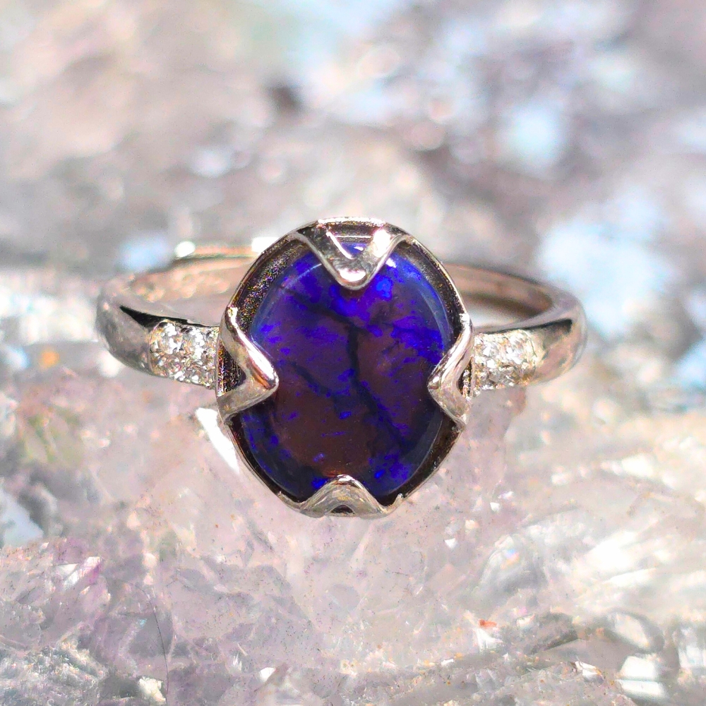 ORCOSPO-1034.1 Aria Quadris adjustable ring in size US 5.75 ( AU L ) with 1.50 Ct oval Lightning Ridge natural dark crystal opal set in 925 sterling silver, showing celestial blue glow