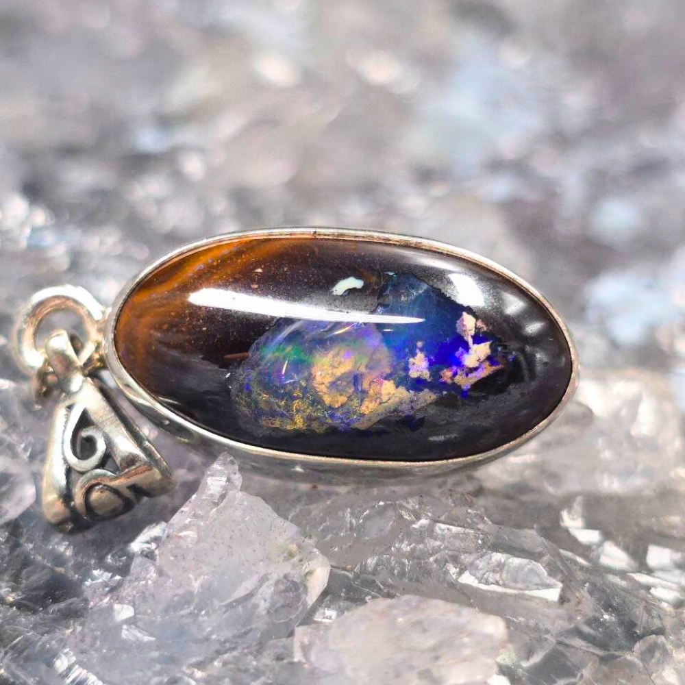 OPBRSPO-1115.7 Somnia Sky, a 9.00 Ct Queensland Natural Boulder opal with Crystal pipe pendant in 925 silver. Ethereal blues, orange, greens, and golds create a celestial luxury piece.