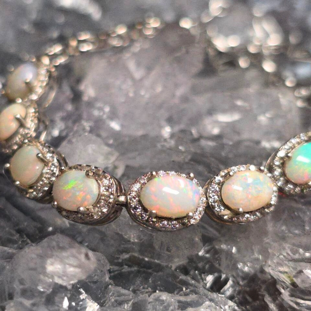ONWOSPO-1151.2 "Pulseira Celestia" 4.00ct Lightning Ridge natural white opal tennis bracelet in 925 silver with basket-prong settings, adjustable chain length 19 cm. 7"-up to 7.5", displaying shifting blue, green, purple, gold, orange, pink fire.