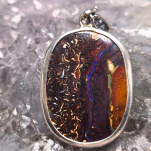 28.00ct natural Queensland natural Boulder Opal with pipe crystal pendant in 925 silver, low dome, freeform cut with blue, green, gold, orange, and purple play-of-colour.