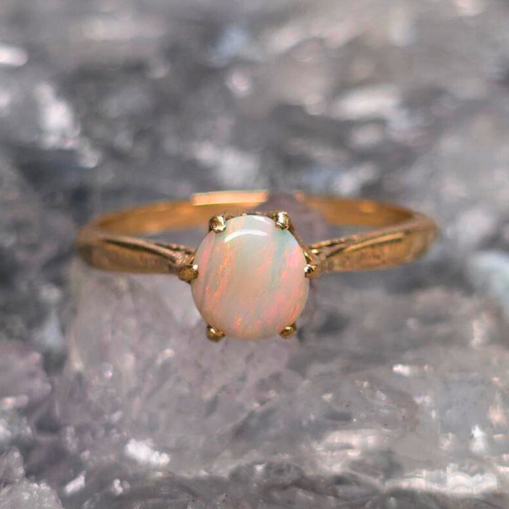 ORWOSPO-1268 (18) Calla Aurelle 9K gold ring featuring a 0.70ct solid, natural White Opal from Lightning Ridge with soft blue, green, gold, orange, and pink play-of-colour in a low dome round cut, size US 8 ( AU P 1/2 ) band