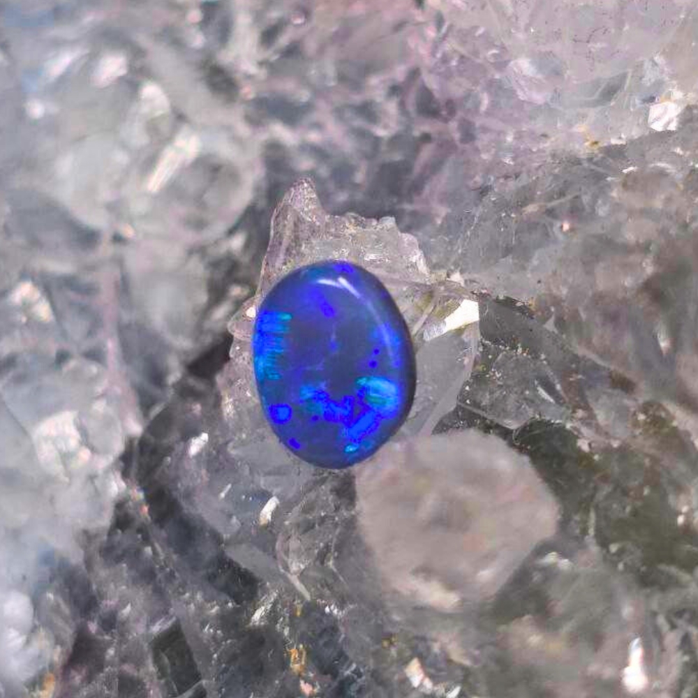 LRBOSPO-1233 (1) Mystra Cielo Lightning Ridge Natural Black Opal 0.65ct oval gemstone displaying vivid blue colour play, N4 body tone, B2 balanced, steady brightness, polished finish, and authentic Australian origin.