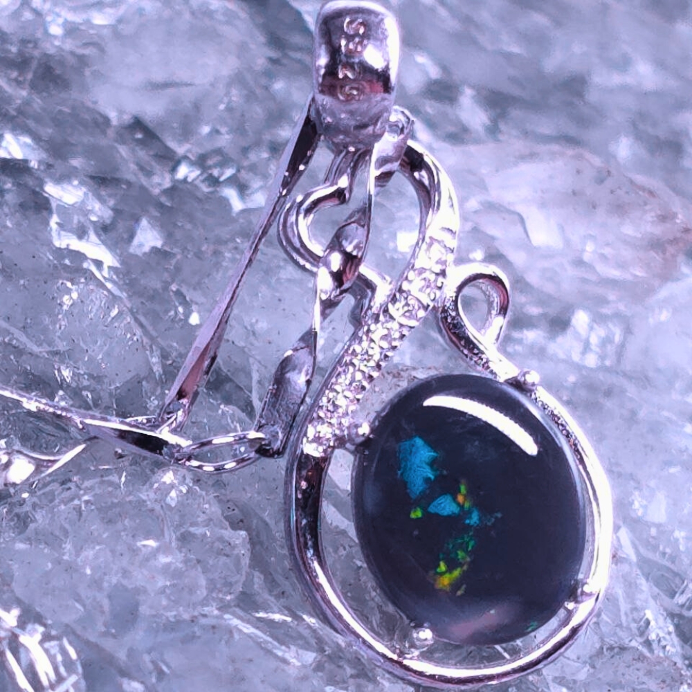 ONBOSPO-1292 (1) "Nerai Lumith" S925 silver necklace featuring a 1.20ct Lightning Ridge Natural Black Opal with vivid blue, green, gold, and pink colour flashes on a dark body tone.