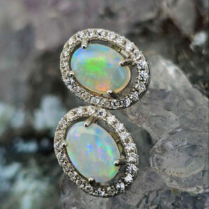 Céline Veya Lightning Ridge natural crystal opal stud earrings in S925 sterling silver with pastel blue, green, orange, and pink fire, showcasing elegant minimalist luxury jewelry.