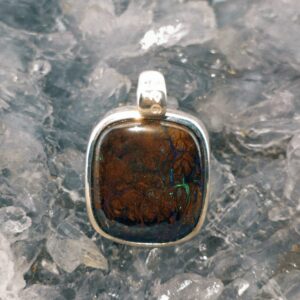 Handmade Natural Queensland Boulder Opal 20.00 ct pendant in S925 silver, displaying vibrant natural colours, rugged polished texture, and elegant earth-inspired craftsmanship.