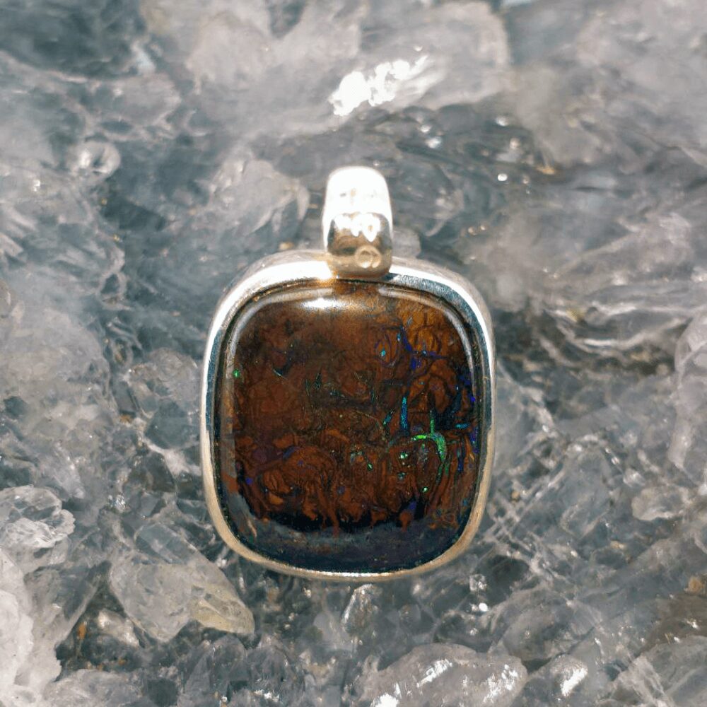 OPBRSPO-1600 (4) Handmade Natural Queensland Boulder Opal 20.00 ct pendant in S925 silver, displaying vibrant natural colours, rugged polished texture, and elegant earth-inspired craftsmanship.