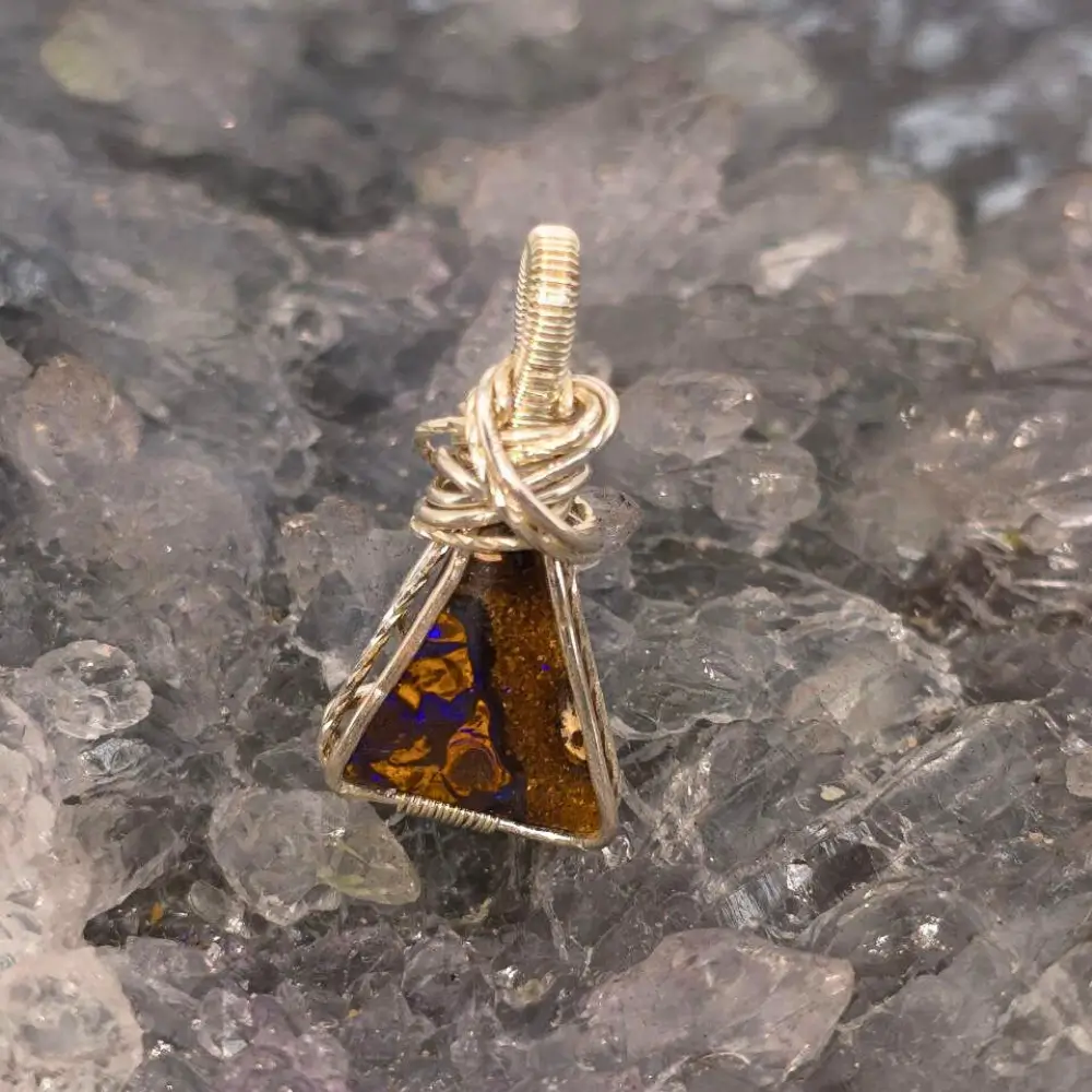 OPBRSPO-1694 (5) Queensland Boulder Opal 4.00ct Wire-Wrapped S925 Pendant showcases a natural triangular opal, handcrafted sterling silver, displaying rich purple hues with elegant craftsmanship.