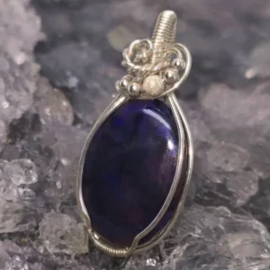 Valyntha Lightning Ridge Black Crystal Opal 15 ct pendant, wire-wrapped in S925 silver, showcasing intense blue play-of-colour and deep N2 bodytone.