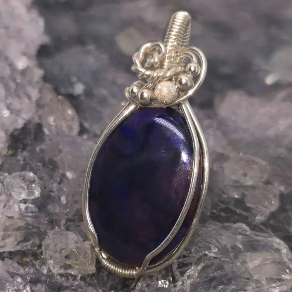 OPCOSPO-1742 (4) Valyntha Lightning Ridge Black Crystal Opal 15 ct pendant, wire-wrapped in S925 silver, showcasing intense blue play-of-colour and deep N2 bodytone.