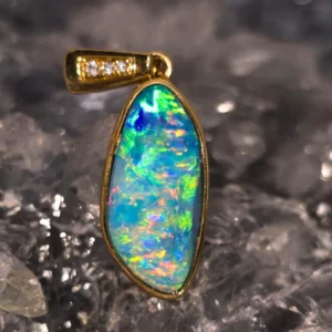 Rayonela handmade 3.00 ct Coober Pedy natural doublet opal pendant in 14 ct yellow gold with natural diamonds, showing vibrant blue, green, pink, and gold play-of-colour.