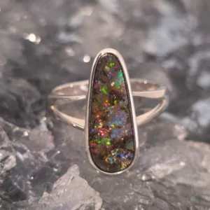 “Nerisse Cleara" rhodium-plated silver ring with 5.00 ct freeform Queensland boulder opal showing blue, green, pink, gold, and red flashes.